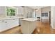 Open kitchen with white cabinets and island connected to the living room at 1740 Manhasset Pl, Atlanta, GA 30338