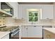 Bright kitchen with white cabinets, stainless steel appliances and countertop at 1740 Manhasset Pl, Atlanta, GA 30338