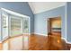 Sunlit living room with hardwood floors, vaulted ceiling, and a large bay window at 1740 Manhasset Pl, Atlanta, GA 30338