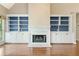 Living room featuring hardwood floors, built-in shelving, a fireplace, and ample natural light at 1740 Manhasset Pl, Atlanta, GA 30338