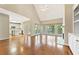 Open living room with hardwood floors, a fireplace, and access to the kitchen and outdoor balcony at 1740 Manhasset Pl, Atlanta, GA 30338