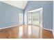 Bright living room featuring hardwood floors, a bay window, and calming blue walls at 1740 Manhasset Pl, Atlanta, GA 30338