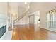 Spacious living room featuring hardwood floors, fireplace, and staircase at 1740 Manhasset Pl, Atlanta, GA 30338