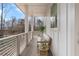 Cozy balcony featuring a cushioned bench, a small table, and views of the surrounding woods at 200 Pinecone Pl, Alpharetta, GA 30022