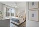 Bedroom features light filled view from a bank of windows and includes stylish decor and a ceiling fan at 200 Pinecone Pl, Alpharetta, GA 30022