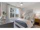 Bedroom features light filled view from a bank of windows and includes stylish decor and a ceiling fan at 200 Pinecone Pl, Alpharetta, GA 30022