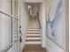 Welcoming entryway with a stairway featuring hardwood treads and an elegant art piece on the wall at 200 Pinecone Pl, Alpharetta, GA 30022