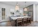 Kitchen island with seating, stainless steel appliances, modern lighting, and ample counter space at 200 Pinecone Pl, Alpharetta, GA 30022