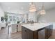 Open-concept kitchen and dining area with hardwood floors and modern lighting at 200 Pinecone Pl, Alpharetta, GA 30022