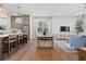 Open concept living space with kitchen, dining area, and living room with hardwood floors at 200 Pinecone Pl, Alpharetta, GA 30022