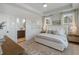 Bright main bedroom with a ceiling fan, large windows, and ensuite bathroom at 200 Pinecone Pl, Alpharetta, GA 30022