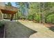 Back yard lawn with patio, woods, garden, and exterior stairs at 2545 Amberbrook Ln, Grayson, GA 30017