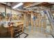 Unfinished basement workshop area with work bench, tools and open ceiling at 2545 Amberbrook Ln, Grayson, GA 30017