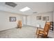 Finished basement with neutral carpet, lighting, and cozy rocking chairs at 2545 Amberbrook Ln, Grayson, GA 30017