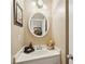 Powder room with a decorative mirror, vanity, lighting, and floral accents at 2545 Amberbrook Ln, Grayson, GA 30017