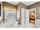 Bright bathroom with a large soaking tub, white cabinets and tile, with bedroom access at 2545 Amberbrook Ln, Grayson, GA 30017