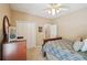 Bedroom featuring a bed, ceiling fan, dresser, closet, and doorway to another room at 2545 Amberbrook Ln, Grayson, GA 30017