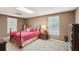 Cozy bedroom with carpet flooring, two windows, and a decorative wooden bed frame at 2545 Amberbrook Ln, Grayson, GA 30017