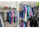 Well-organized walk-in closet featuring clothing racks and shelves for storage at 2545 Amberbrook Ln, Grayson, GA 30017