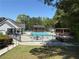 Beautiful community pool featuring a lap area, tables, and gazebo surrounded by lush greenery on a sunny day at 2545 Amberbrook Ln, Grayson, GA 30017