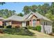 Brick and vinyl home with lush landscaping and a well-manicured front yard at 2545 Amberbrook Ln, Grayson, GA 30017
