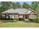 Charming single-story brick home featuring a well-manicured lawn and mature landscaping at 2545 Amberbrook Ln, Grayson, GA 30017
