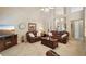 Cozy living room features leather sofas, a ceiling fan, and neutral carpeting at 2545 Amberbrook Ln, Grayson, GA 30017