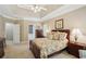 Main bedroom with a tray ceiling and a view to an en-suite bathroom at 2545 Amberbrook Ln, Grayson, GA 30017