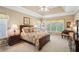 Comfortable main bedroom with a tray ceiling and classic furnishings at 2545 Amberbrook Ln, Grayson, GA 30017
