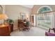 Bright office space with a large arched window and a traditional wooden desk at 2545 Amberbrook Ln, Grayson, GA 30017