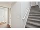 Carpeted stairway with white handrail provides access to upper or lower level at 2545 Amberbrook Ln, Grayson, GA 30017