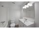 Bright white bathroom features a shower/tub combo, toilet, white vanity, light fixture, and wood-look floors at 2896 Lakemont Sw Dr, Marietta, GA 30060