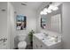 A bright and clean bathroom featuring a sleek vanity, modern fixtures, and an adjacent shower with white tiling at 2896 Lakemont Sw Dr, Marietta, GA 30060