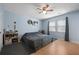A comfortably styled bedroom with a ceiling fan, wood floors, and natural light from two windows at 2896 Lakemont Sw Dr, Marietta, GA 30060