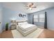 Serene bedroom with a plush bed, hardwood floors, and ample natural light from two windows at 2896 Lakemont Sw Dr, Marietta, GA 30060
