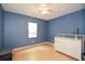 Cozy bedroom with wood-look floors, blue walls, a white dresser, and a bright window at 2896 Lakemont Sw Dr, Marietta, GA 30060