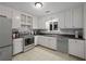 An efficient kitchen featuring white cabinets, subway tile backsplash, and updated appliances at 2896 Lakemont Sw Dr, Marietta, GA 30060