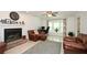 Cozy living room featuring a brick fireplace, bay window, and comfortable leather seating at 2896 Lakemont Sw Dr, Marietta, GA 30060