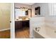 Well-lit bathroom featuring a double vanity, soaking tub, and tile accents at 65 Woodside Ct, Mcdonough, GA 30253