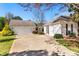 Exterior showing the home's white siding, driveway, and a detached garage on a sunny day at 65 Woodside Ct, Mcdonough, GA 30253