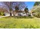Charming one story home with a well-manicured lawn, mature trees, and inviting curb appeal at 65 Woodside Ct, Mcdonough, GA 30253