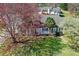 Aerial view of a home with a well-manicured lawn and mature trees at 65 Woodside Ct, Mcdonough, GA 30253