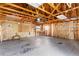 Spacious garage with shelving, workbench, and visible insulation at 65 Woodside Ct, Mcdonough, GA 30253