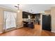 Eat-in kitchen with dark cabinets, stainless steel appliances, and wood flooring at 65 Woodside Ct, Mcdonough, GA 30253