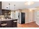 Well-lit kitchen featuring dark cabinets, stainless steel appliances, and an island at 65 Woodside Ct, Mcdonough, GA 30253