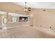 Spacious living room with neutral carpeting, ceiling fan, and lots of natural light at 65 Woodside Ct, Mcdonough, GA 30253