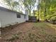 This backyard includes a screen porch and lots of tree coverage at 1228 Reilly Ln, Clarkston, GA 30021