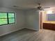 This bedroom features a ceiling fan, hardwood floors, and an abundance of natural light at 1228 Reilly Ln, Clarkston, GA 30021