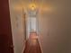 This hallway has hardwood floors and white painted walls, leading through several doorways at 1228 Reilly Ln, Clarkston, GA 30021