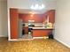 Cozy kitchen with orange cabinets, stainless steel appliances, and ample counter space at 1228 Reilly Ln, Clarkston, GA 30021